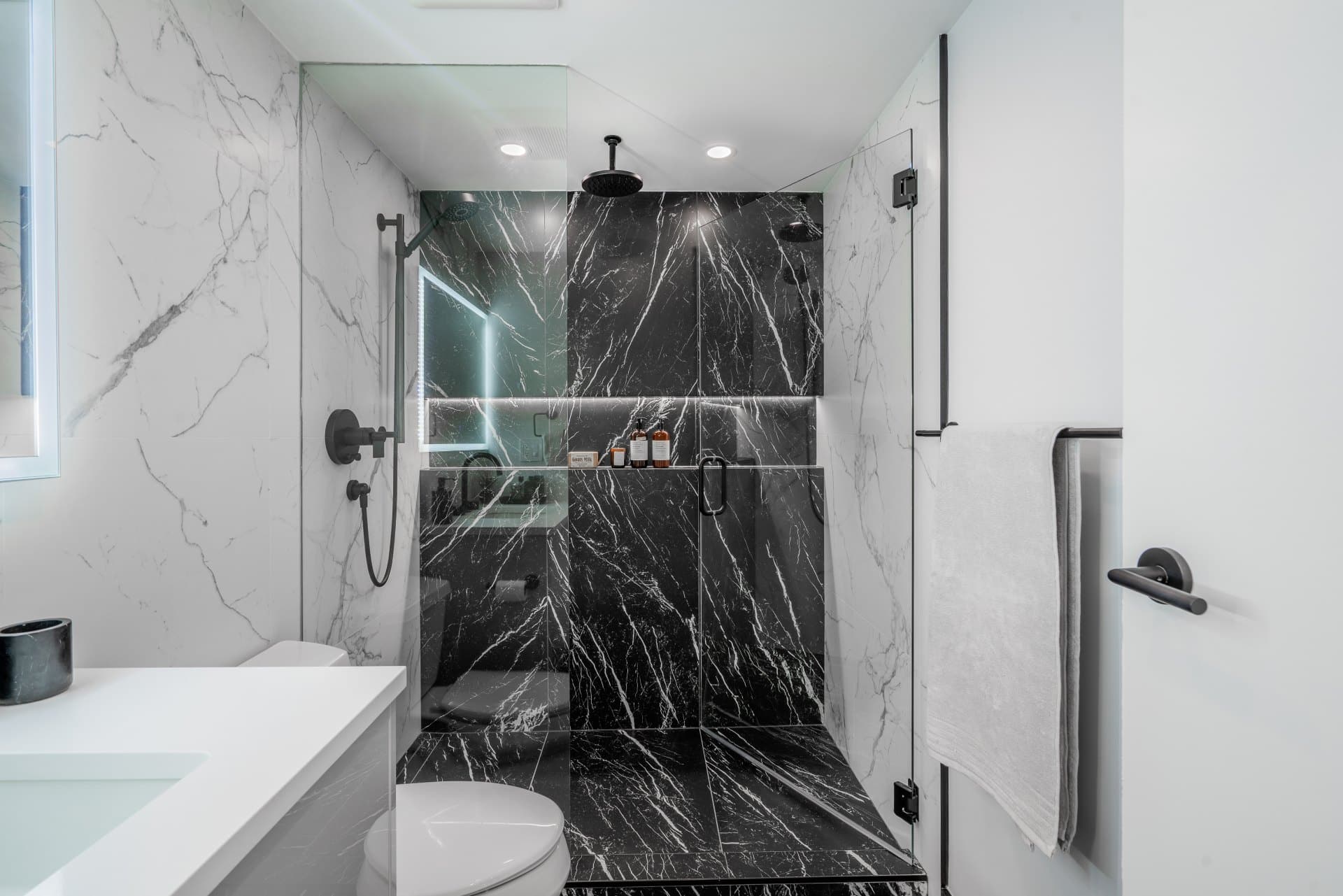 Bathroom-renovation-black-white-marble-black-plumbing-fixtures