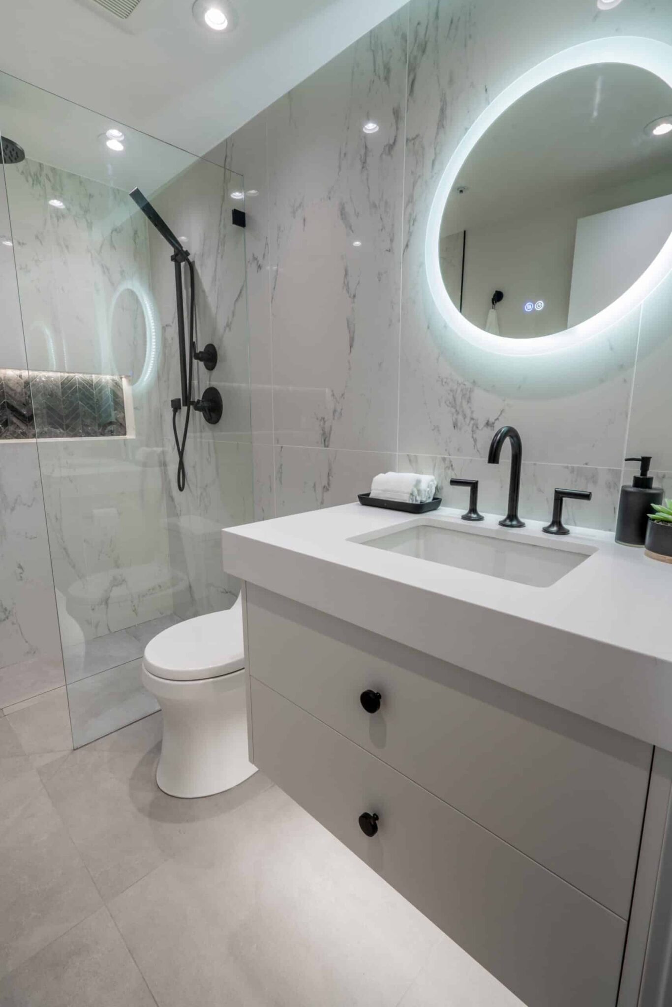Bathroom-modern-remodel-round-led-mirror-black-plumbing-fixtures