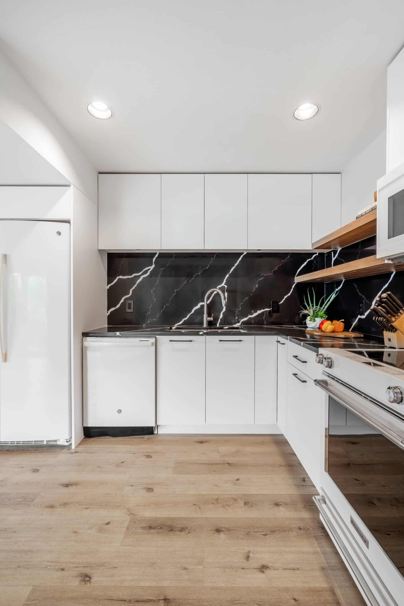 kitchen-luxury-basement-white-cabinet-vancouver-renovation-marble-black-countertop
