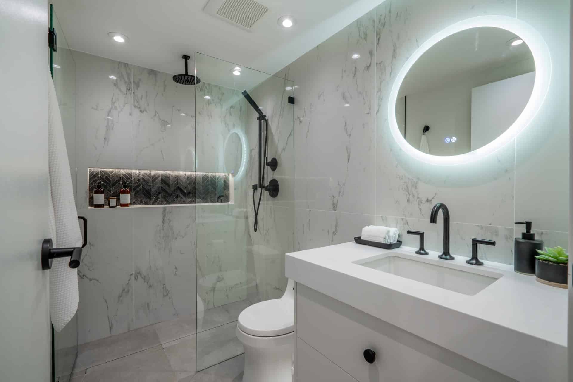 modern-bathroom-renovation-black-faucet-fixtures-marble-tile