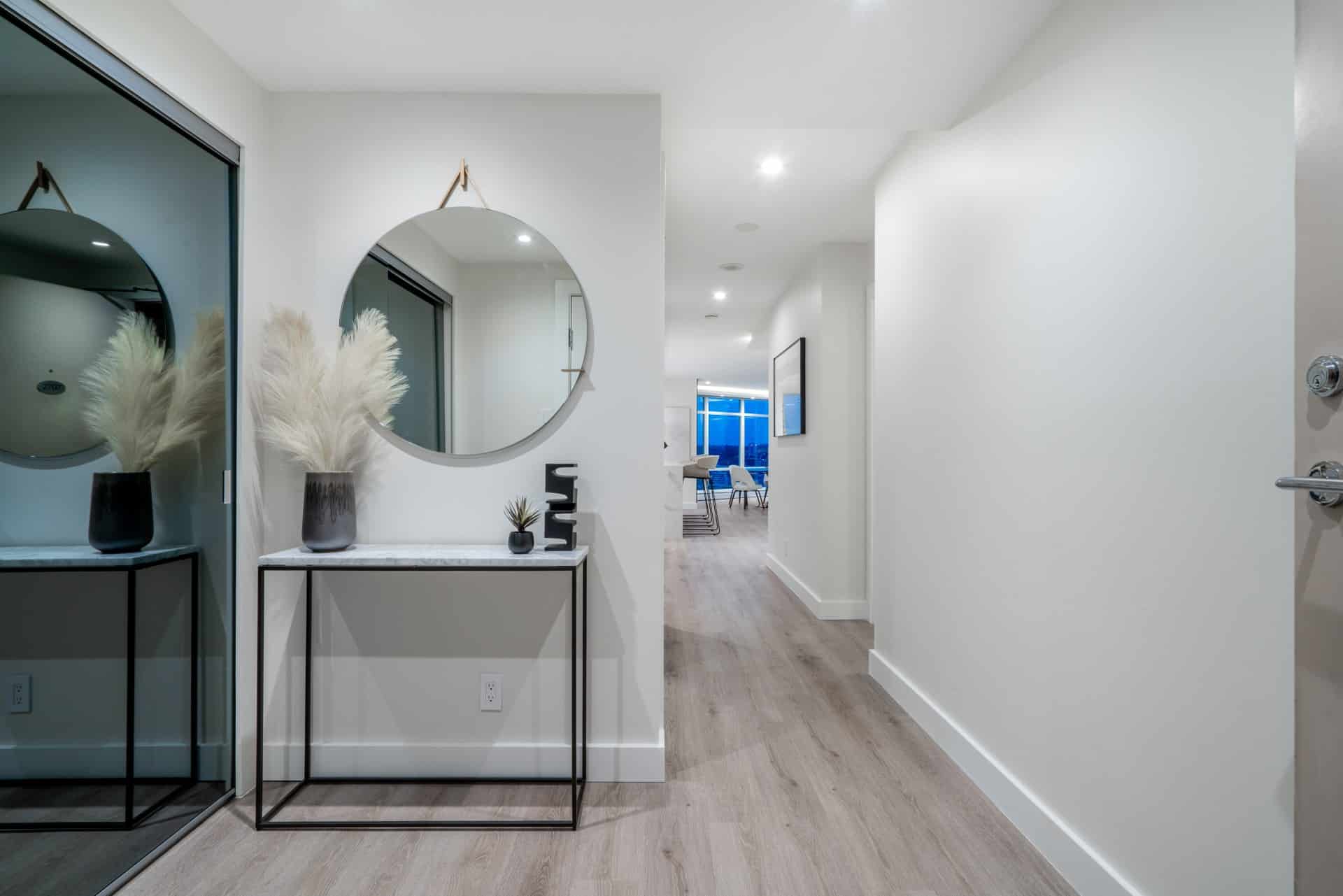 modern-foyer-interior-design-vanyl-flooring-round-mirror-cb2-table