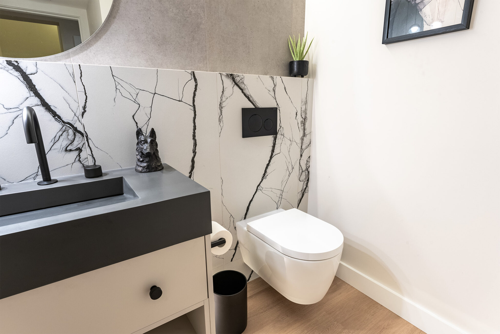powder-room-floating-toilet-marble-backsplash-black-white-laminate-flooring